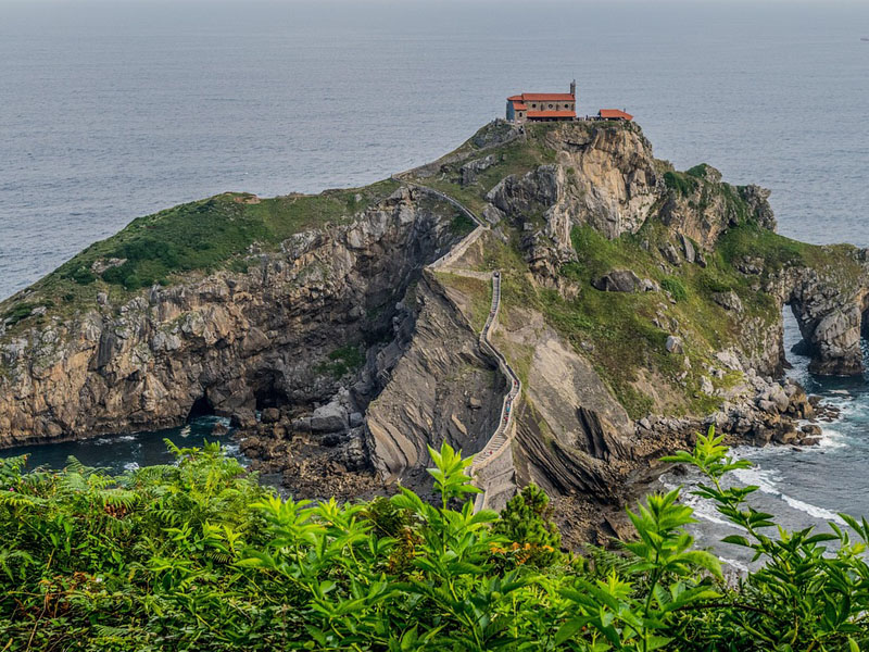 Baskenland: Felsen im Meer mit Klosteranlage